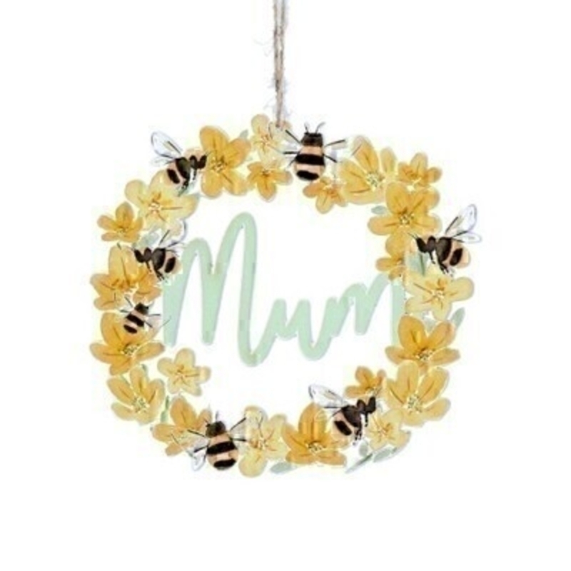A bright yellow wooden hanging decoration featuring yellow buttercups and bees with MUM written inside the cut out. Made by London based designer Gisela Graham who designs really beautiful gifts for your home and garden.  Would suit any home decor and would make a lovely gift for your Mum. 
